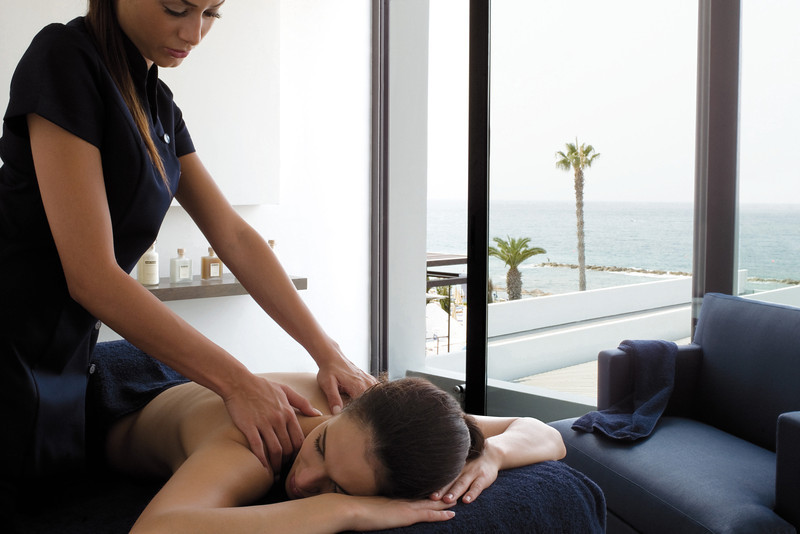 Back and shoulder massage in a bright spa setting in Paphos